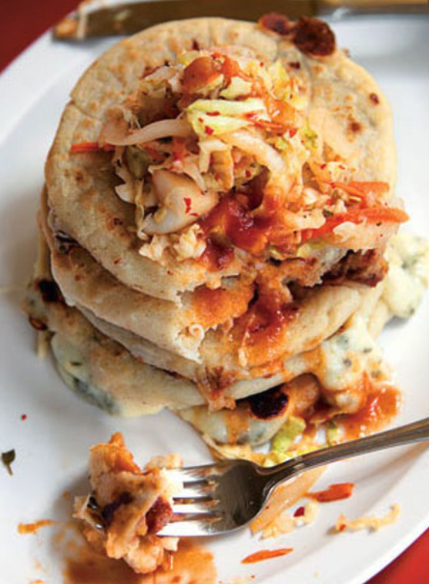 A pupusa is a thick griddle cake or flatbread from El Salvador and Honduras, made with cornmeal or rice flour, similar to the Venezuelan and Colombian arepa. In El Salvador, it has been declared the national dish and has a specific day to celebrate it.